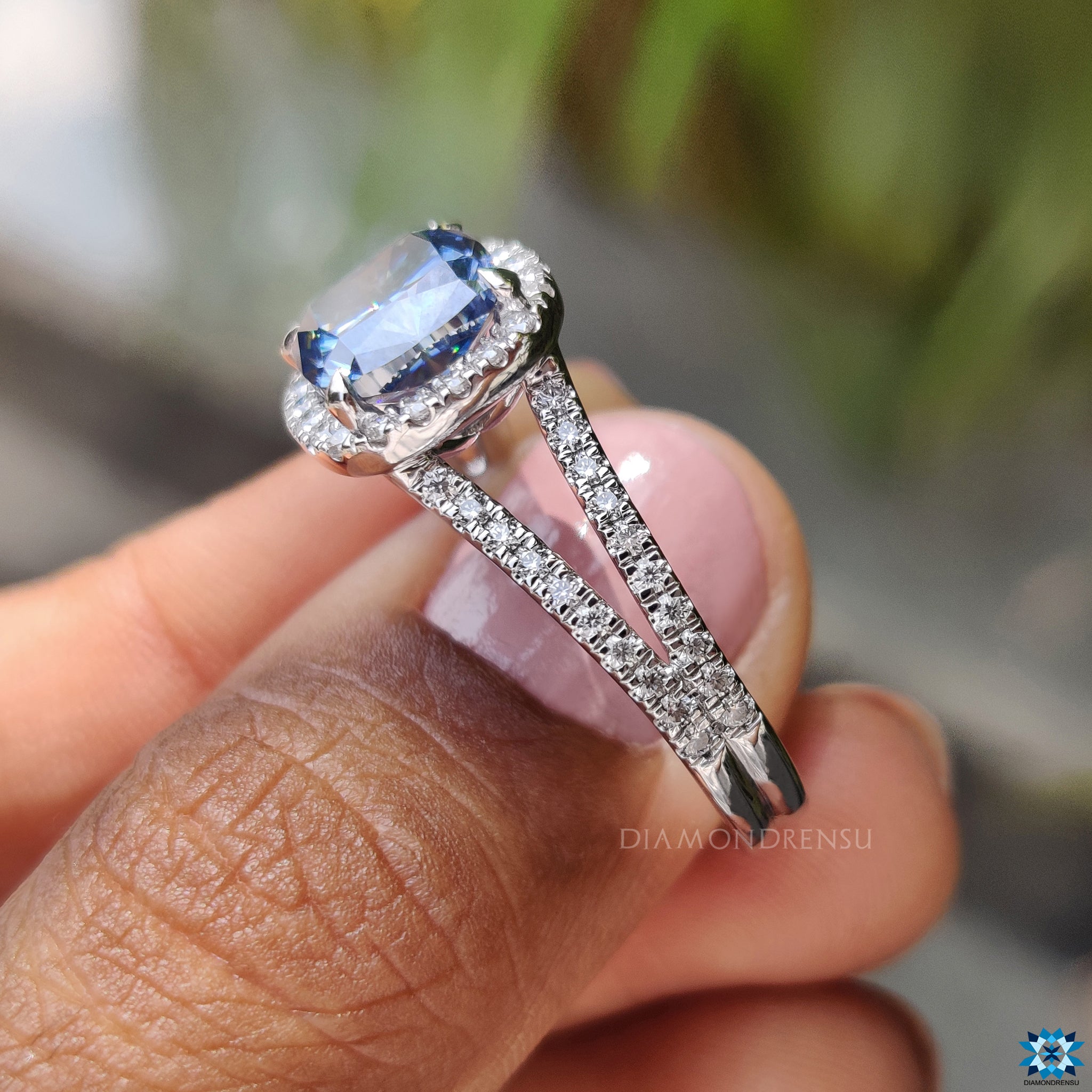 Handmade jewelry engagement ring with royal blue cushion cut moissanite and halo.
