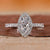 Marquise halo engagement ring in white gold.
