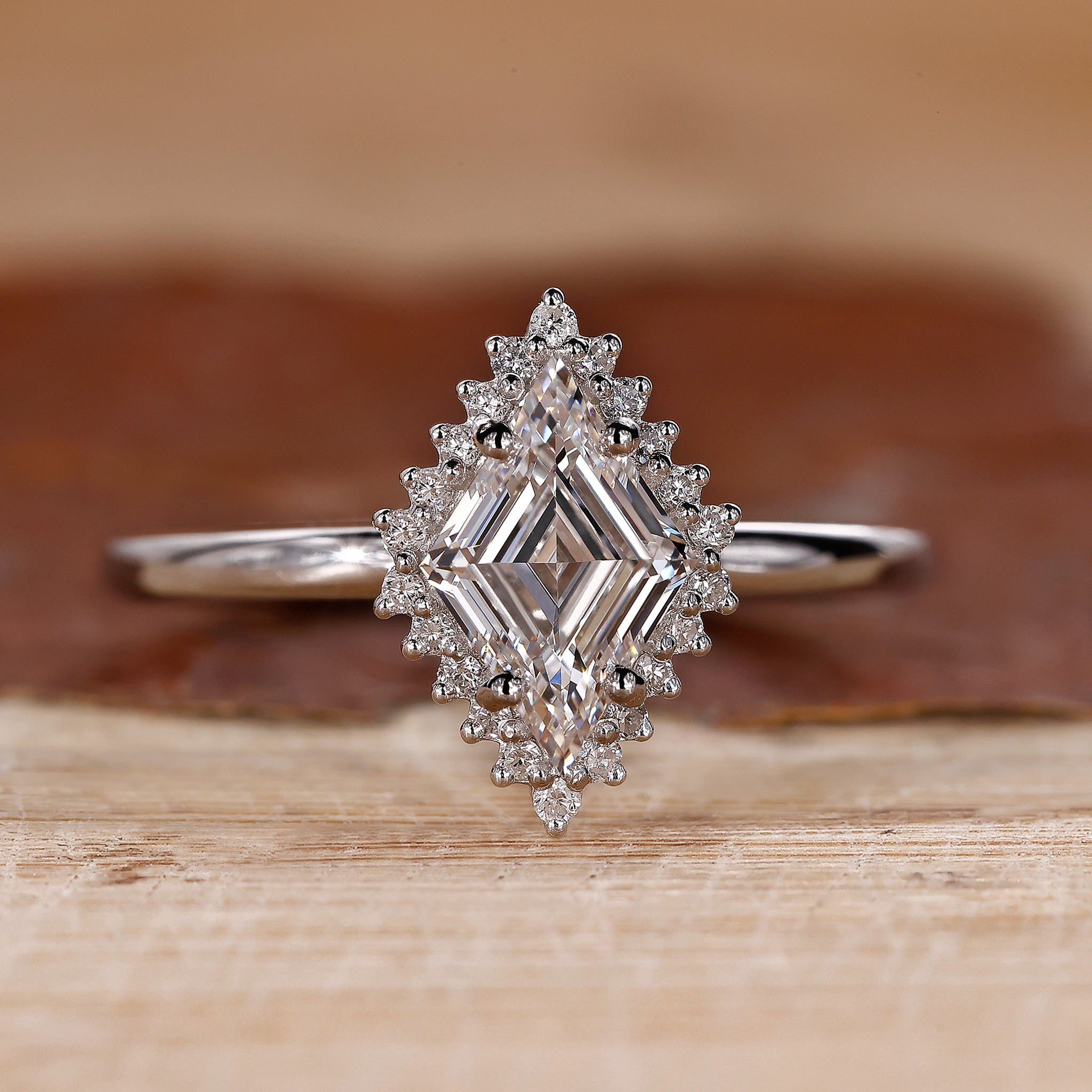 Halo diamond engagement ring with lozenge cut diamond center stone.
