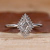 Halo diamond engagement ring with lozenge cut diamond center stone.
