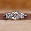 3 stone round diamond ring with trellis setting in white gold.
