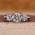 3 stone round diamond ring with trellis setting in white gold.
