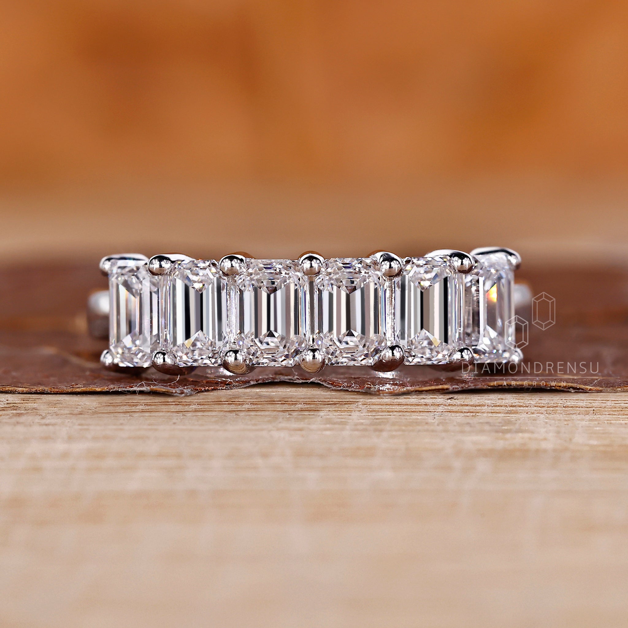 Shared prong diamond band with secure settings.
