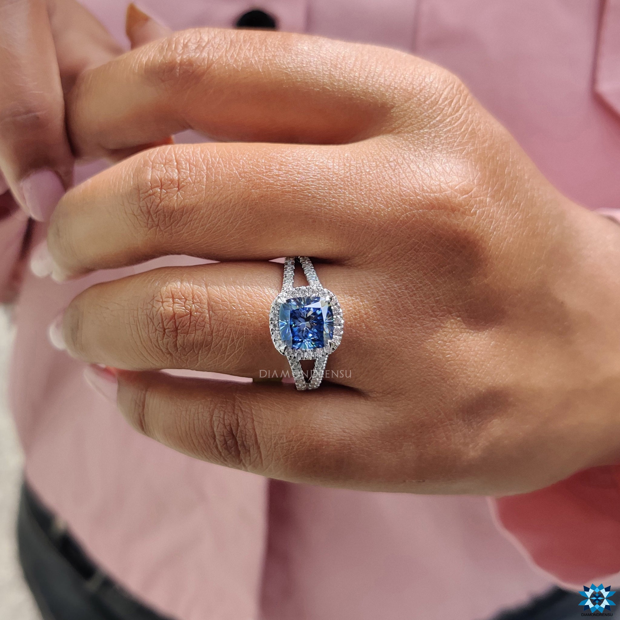 Elegant cushion moissanite ring with 4 claw prong halo and white gold pave shank.
