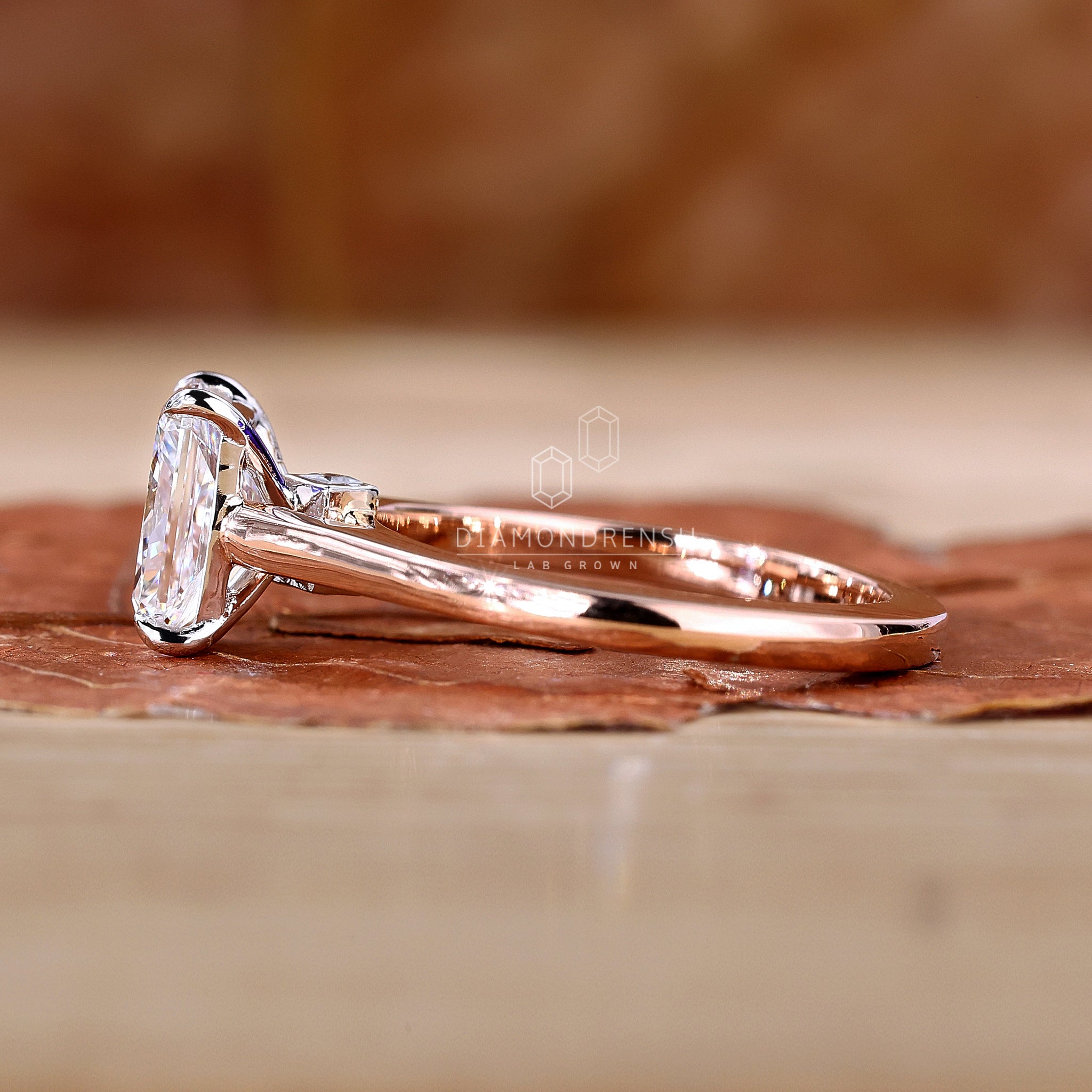 White gold ring with radiant cut center diamond.
