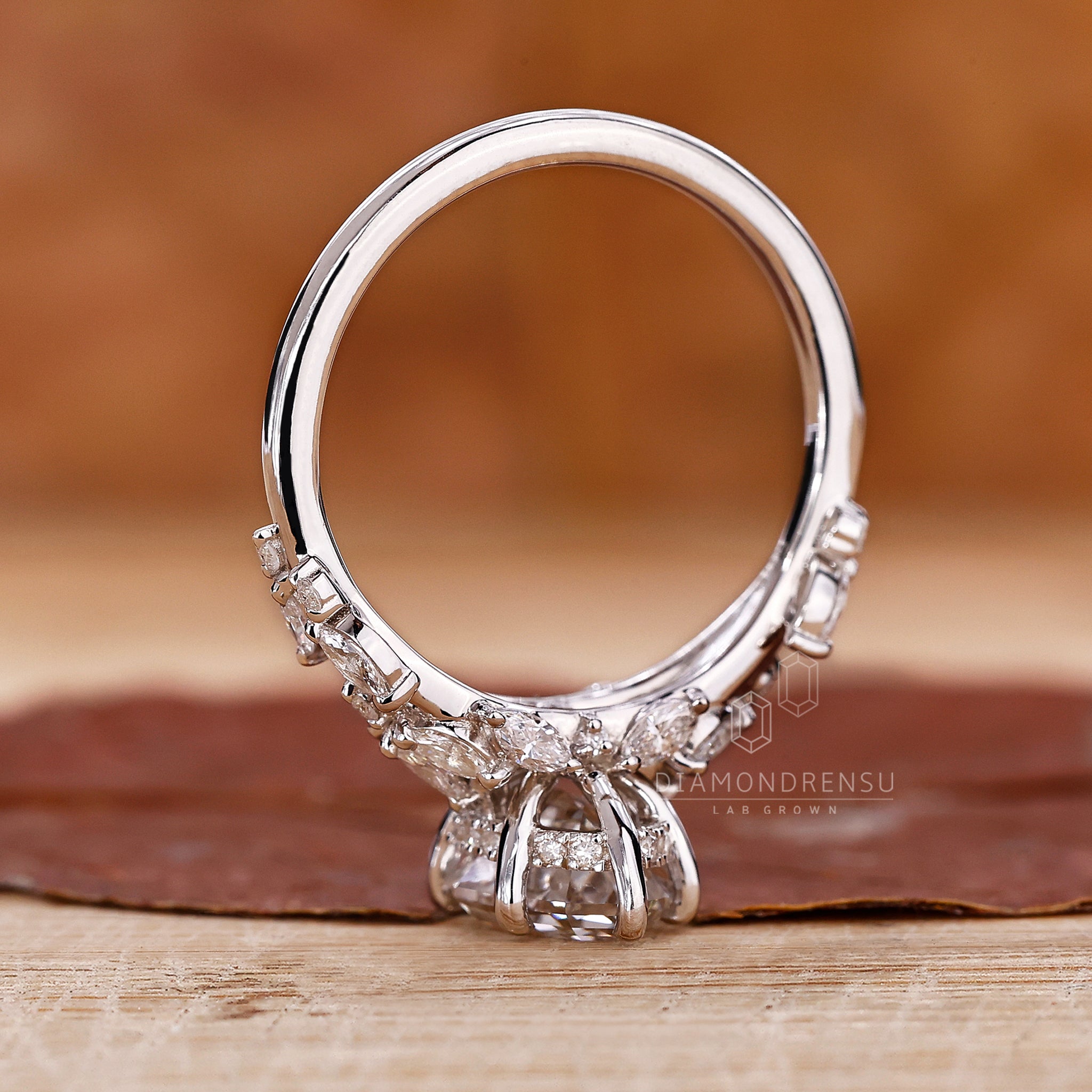 Prong setting ring with an oval step cut diamond centerpiece.