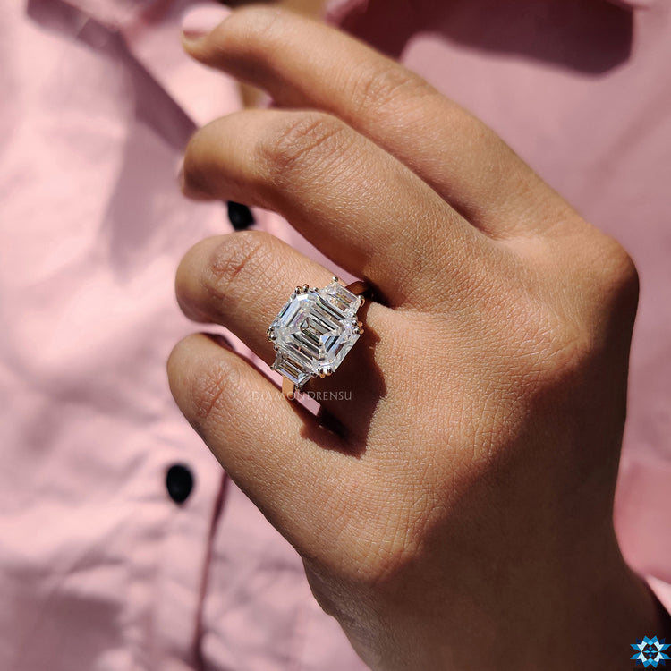 Handmade jewellery with emerald cut moissanite and unique side stone setting.
