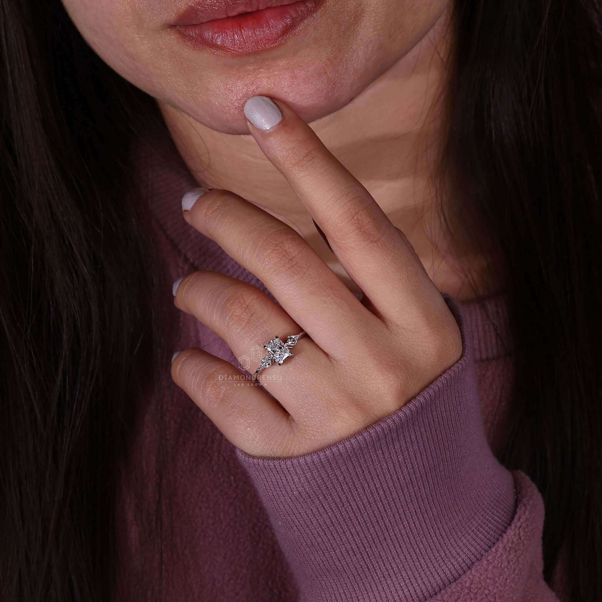 Three stone engagement ring featuring a radiant cut diamond and a 4 prong claw setting.
