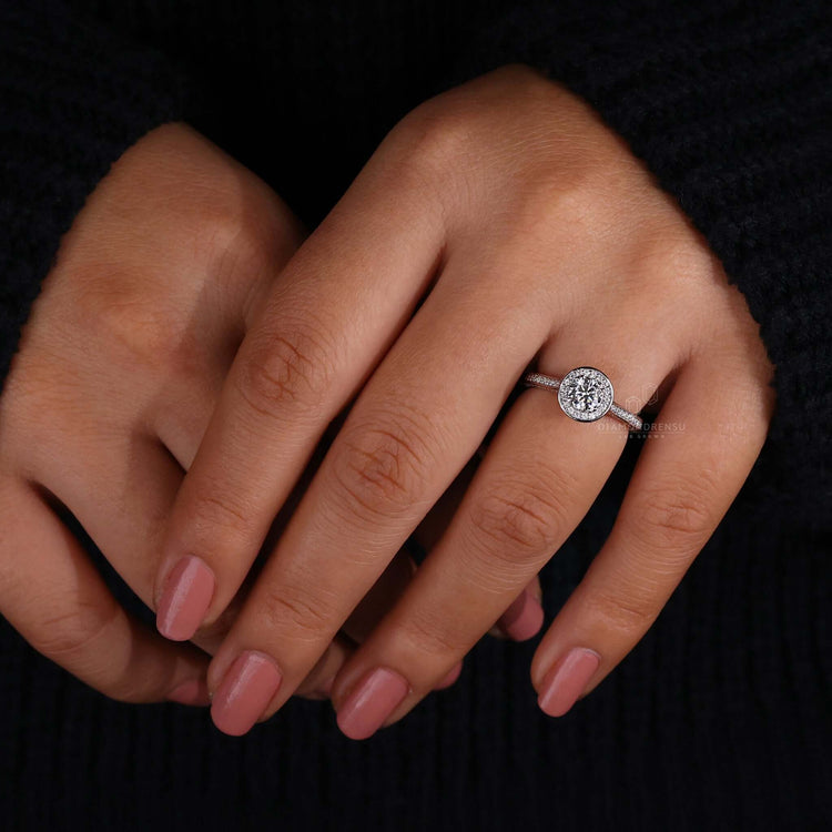 4 prong engagement ring showcasing a halo diamond ring paired with a cathedral setting design.
