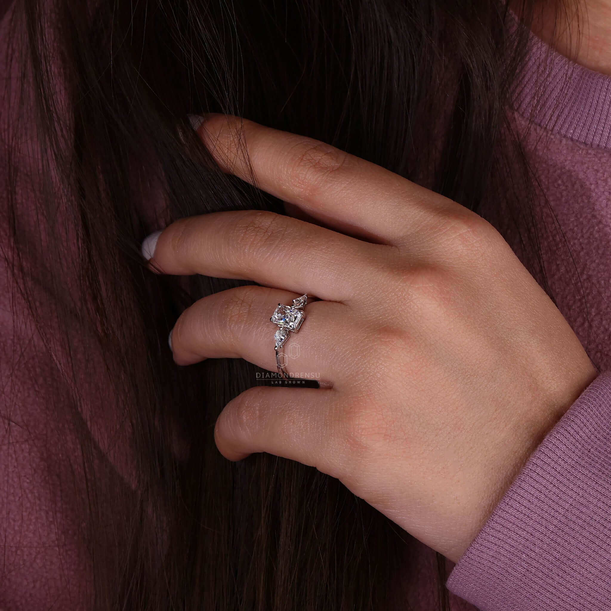 White gold ring paired with a radiant cut diamond ring for a classic engagement look.
