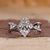 Marquise cut diamond ring with twisted pave engagement design.
