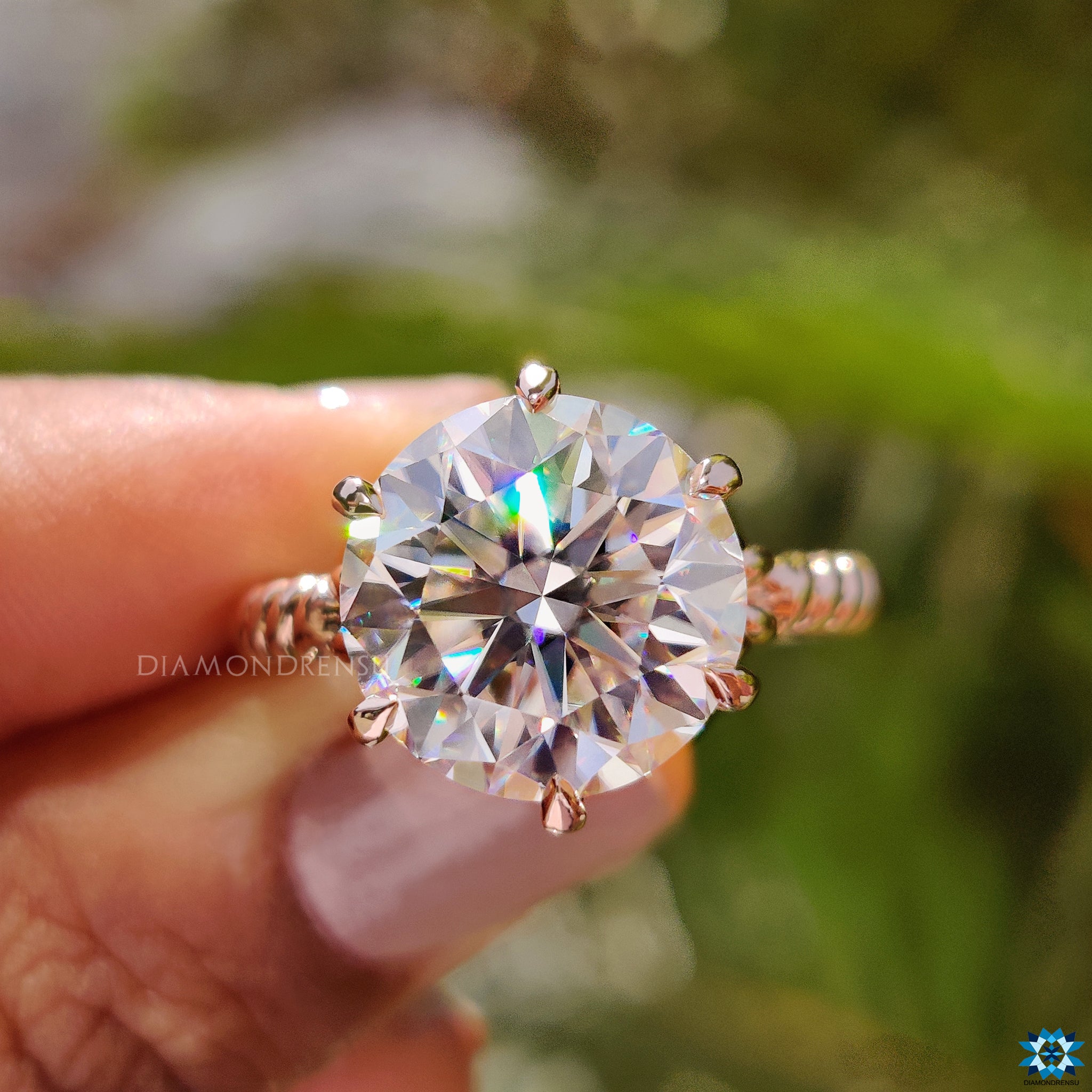 Handmade round cut engagement ring in twisted rose gold solitaire style.
