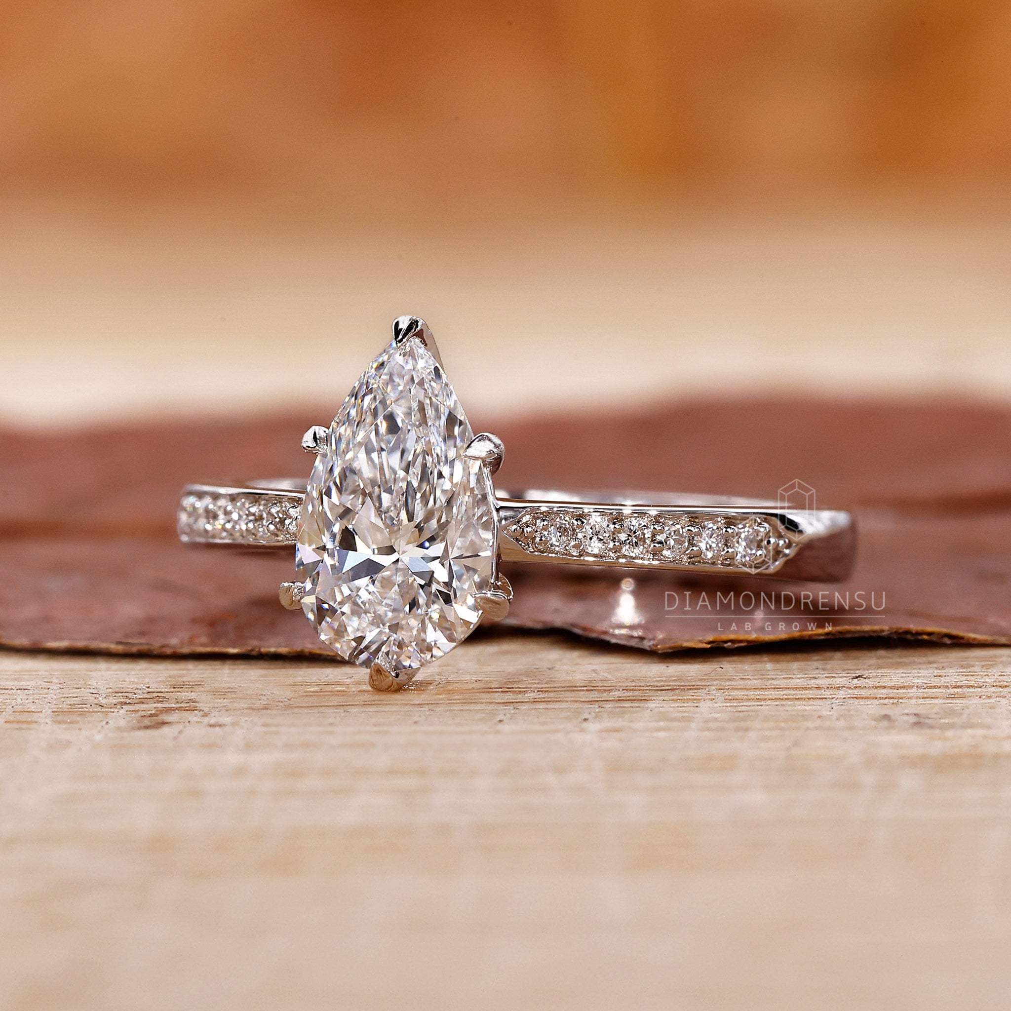 Pear diamond ring crafted in pave setting style.
