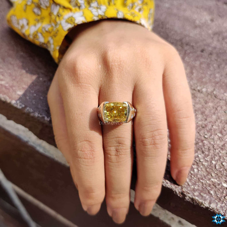 Flush setting cushion cut moissanite ring crafted in yellow gold.
