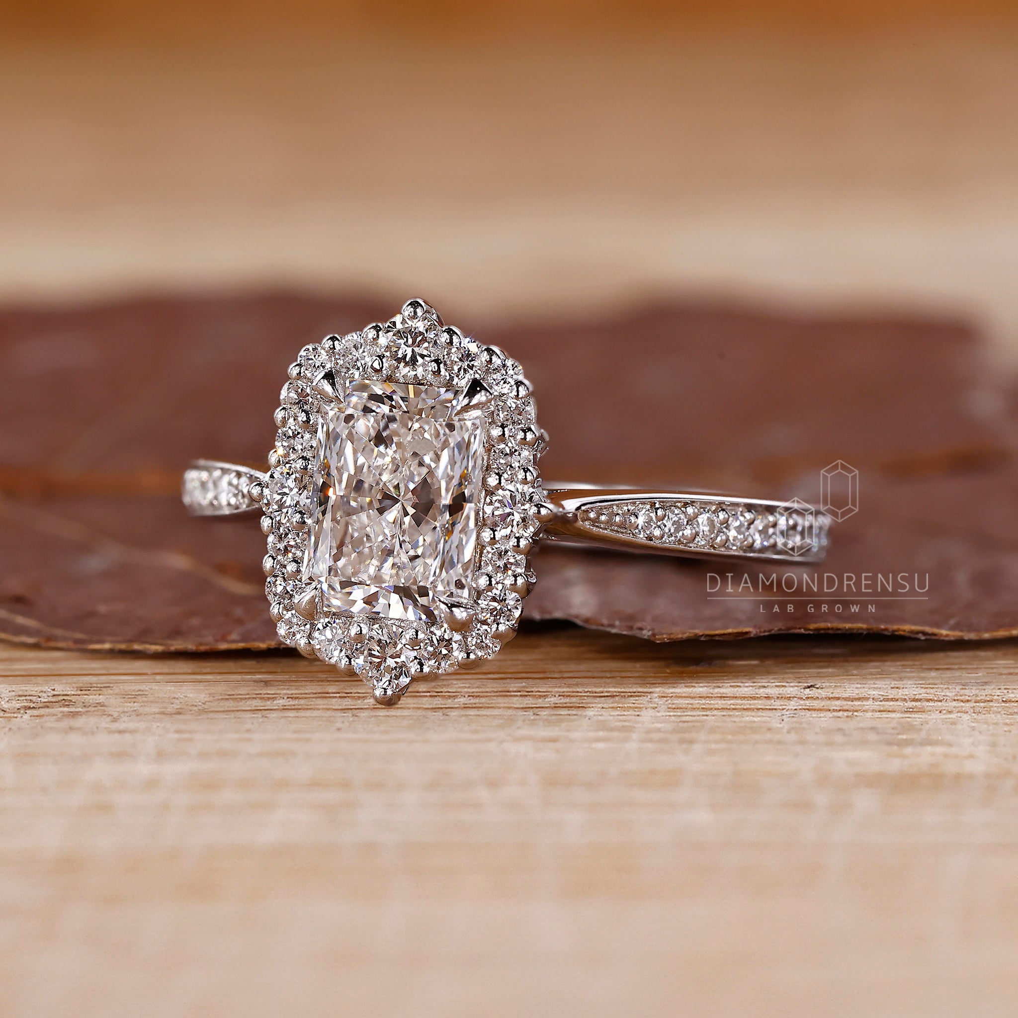 Round diamond halo setting around radiant center.

