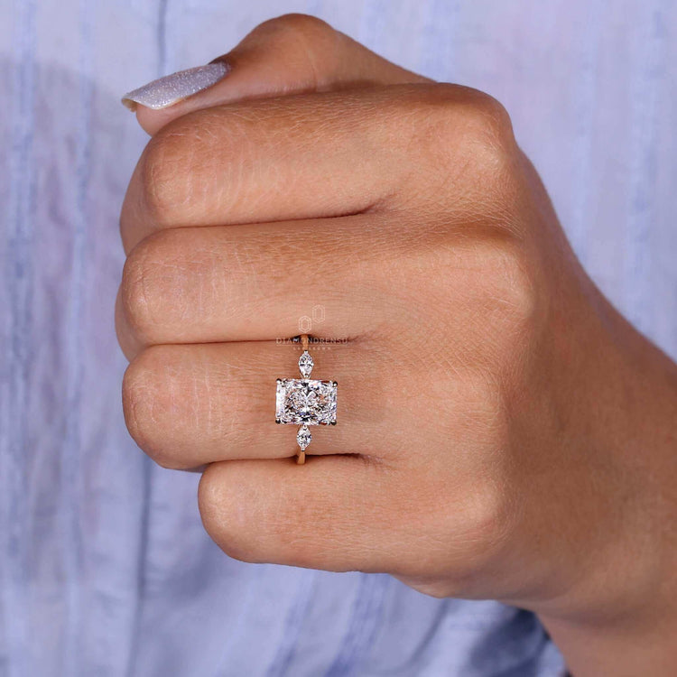 Radiant cut engagement ring paired with a three stone diamond ring for a bold and elegant look.
