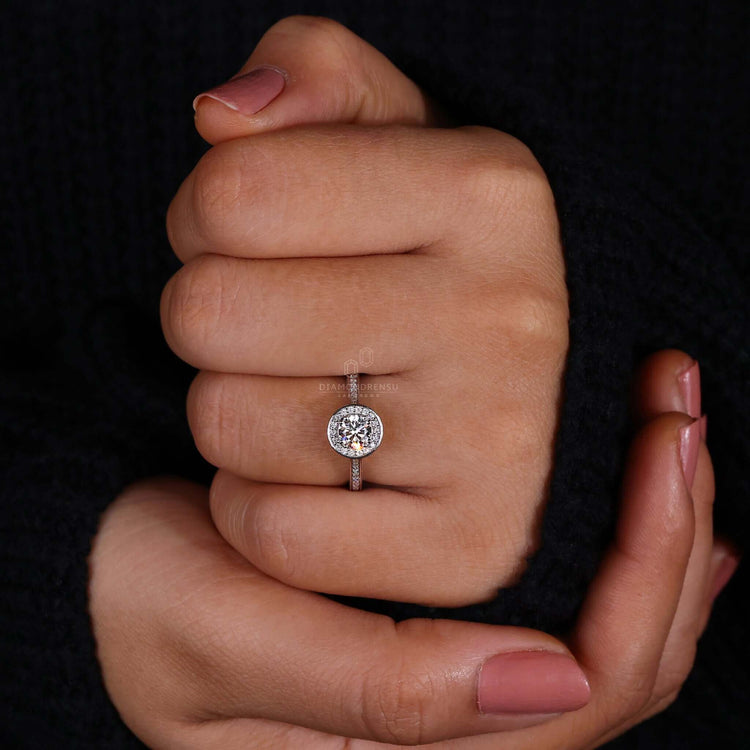 Bezel engagement ring with a halo setting and side stone engagement ring details for added brilliance.
