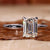 Stunning 2 carat emerald cut ring in elegant white gold design.