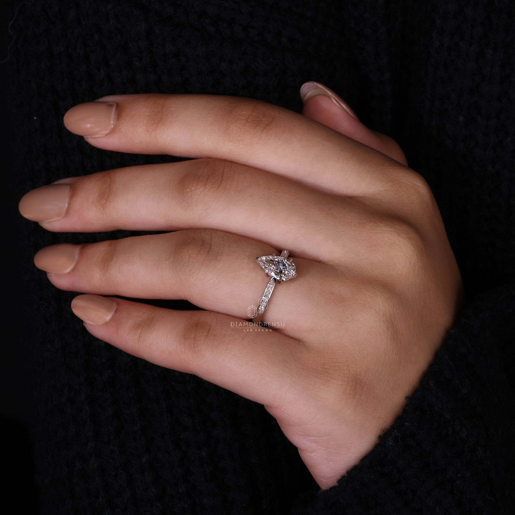 White gold engagement ring with pear diamond ring.
