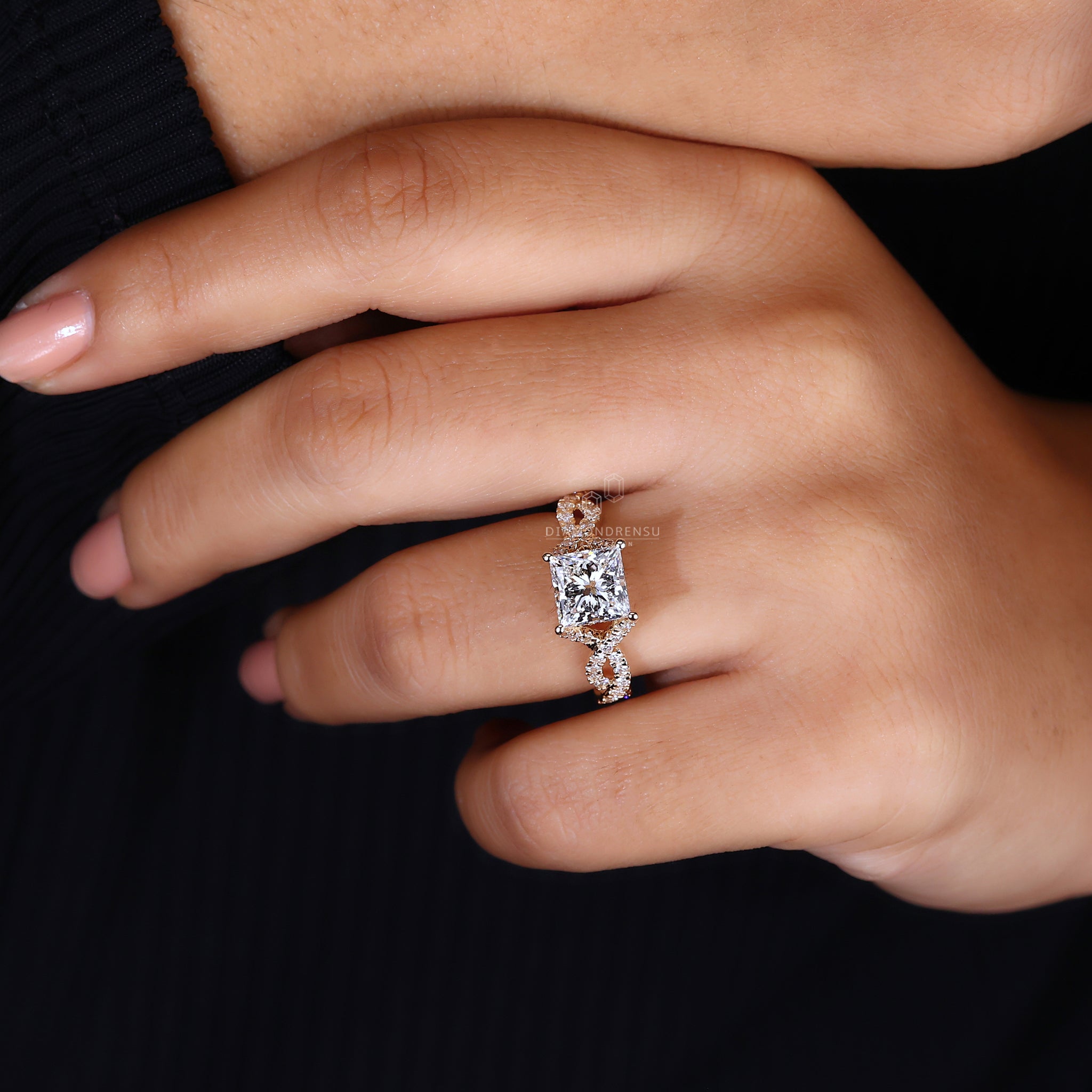 UK engagement ring includes princess cut and round diamond accents.
