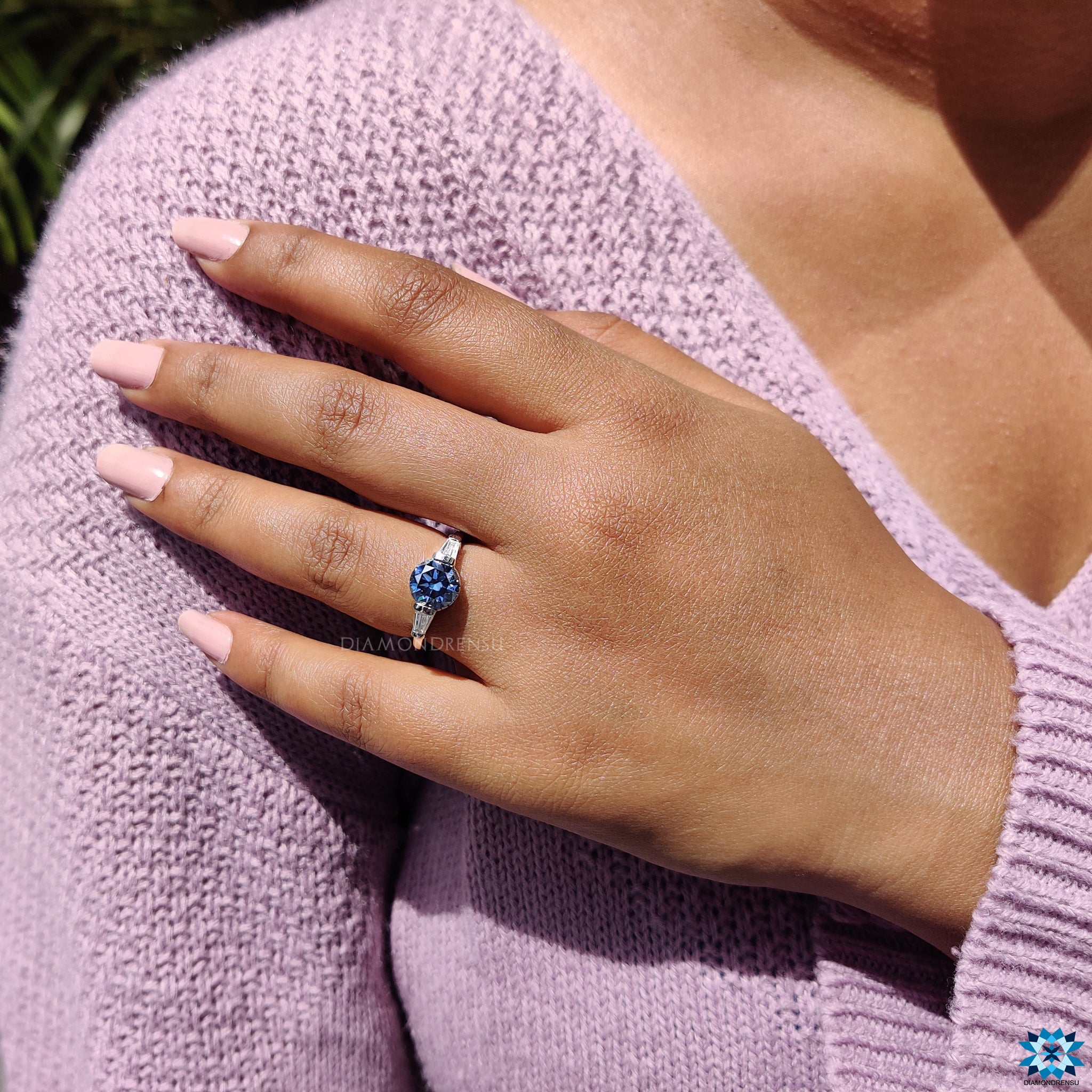 Diamondrensu UK engagement ring in white gold with deep blue stone.
