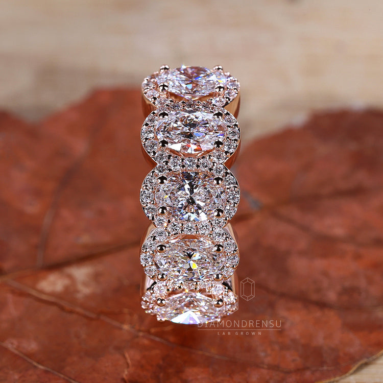 Round cut diamond halo ring with a bright centre and carefully placed accent stones.
