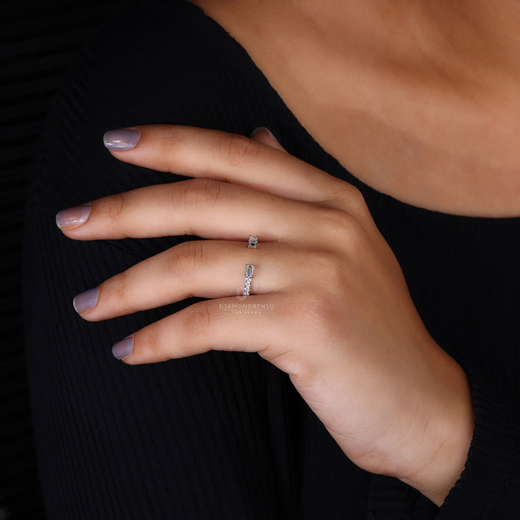 Elegant open wedding band with emerald and round diamonds
