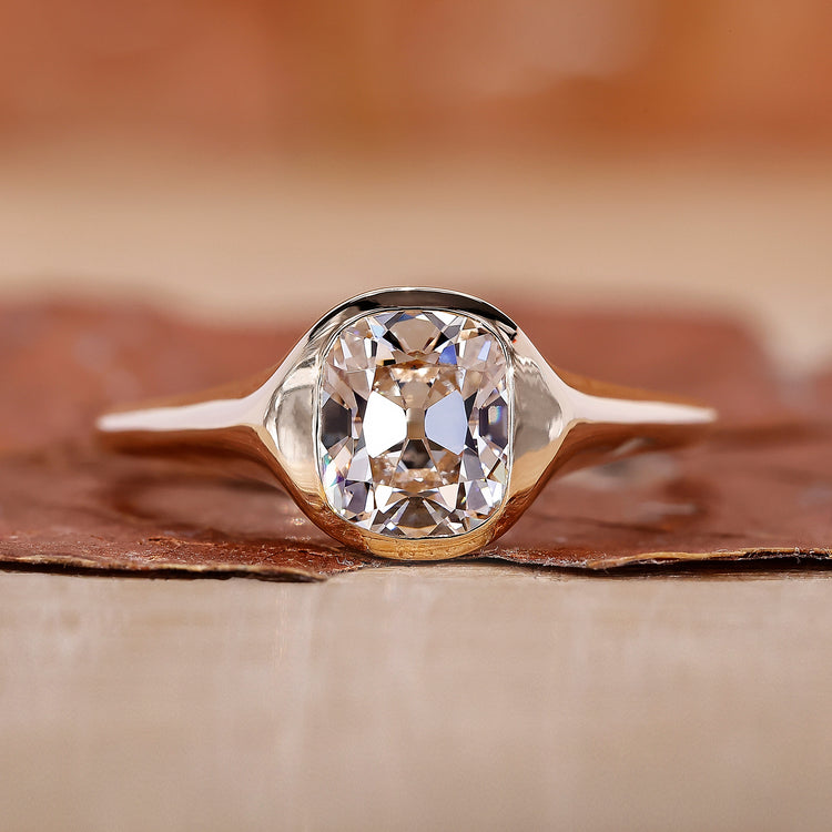 Gold signet ring with old mine cushion cut diamond ring.

