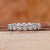 Bezel set eternity wedding band in white gold.

