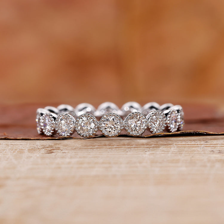 Bezel set eternity wedding band in white gold.
