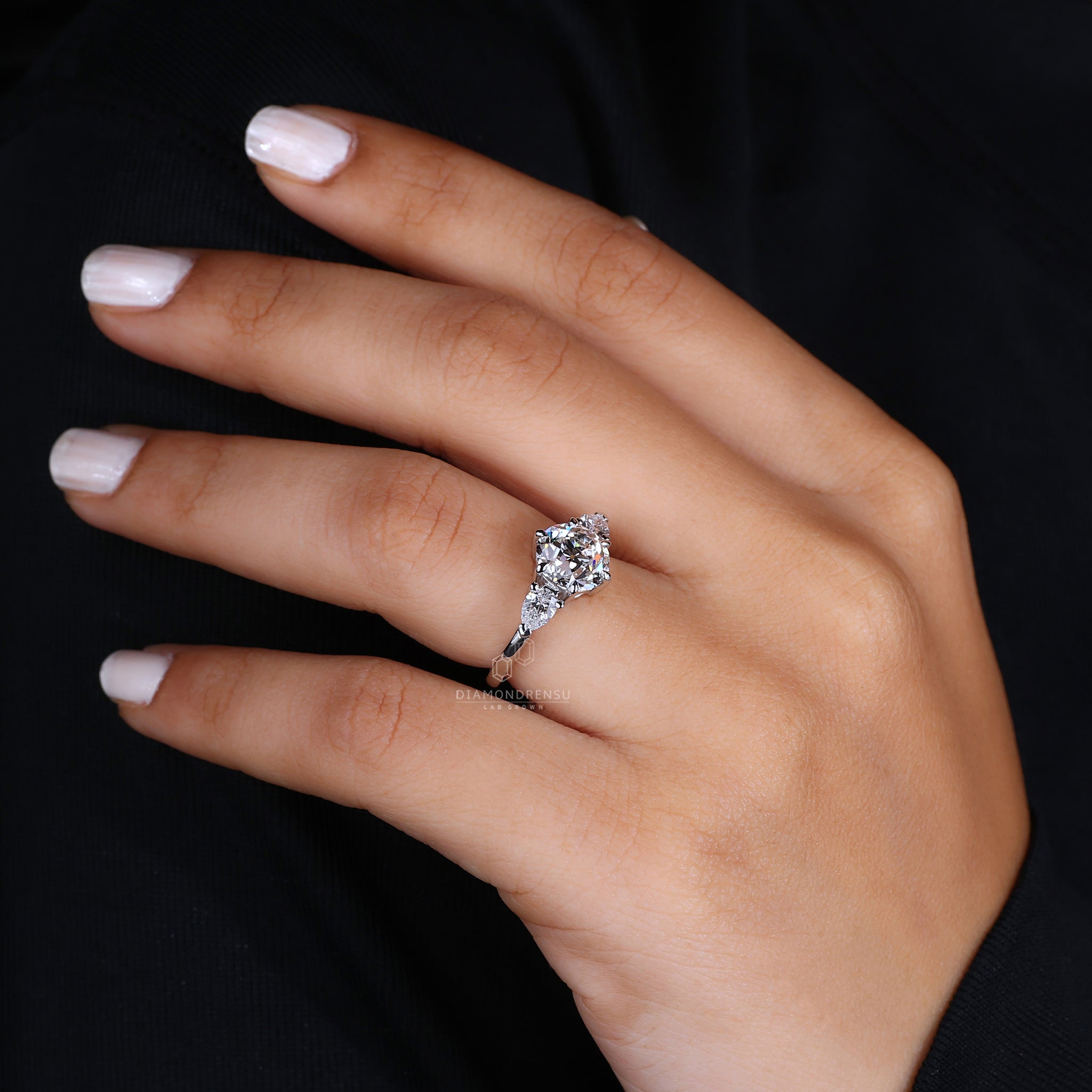 Pear cut diamond accents on white gold ring.
