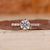 Round diamond ring with pave set band in yellow gold.
