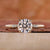 Round cut diamond ring with sparkling stones.
