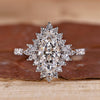 Marquise halo engagement ring with pave setting in white gold.
