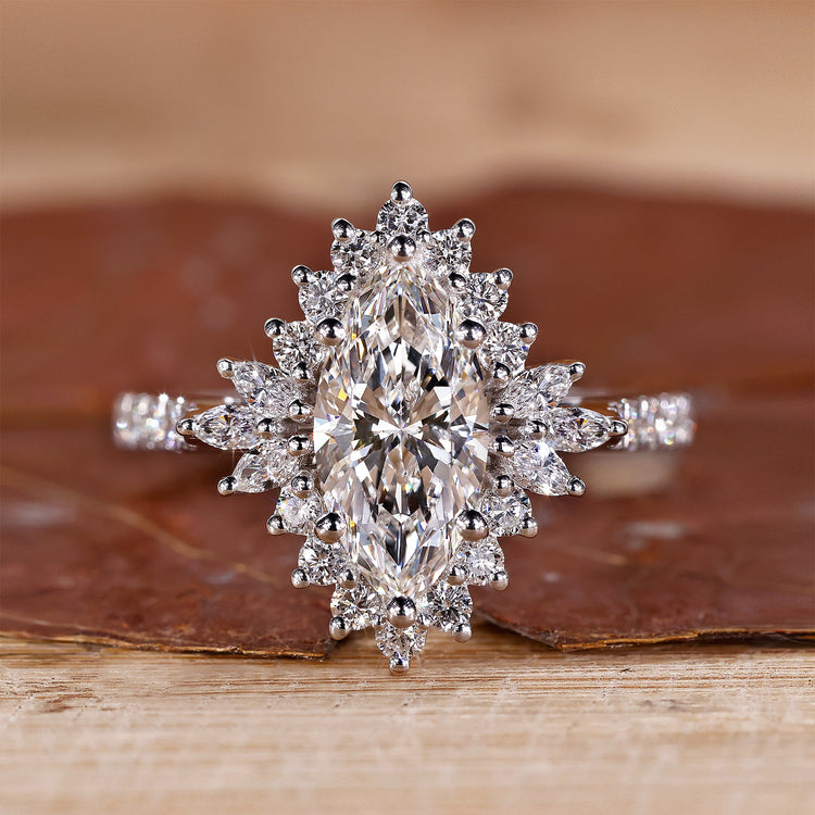 Marquise halo engagement ring with pave setting in white gold.
