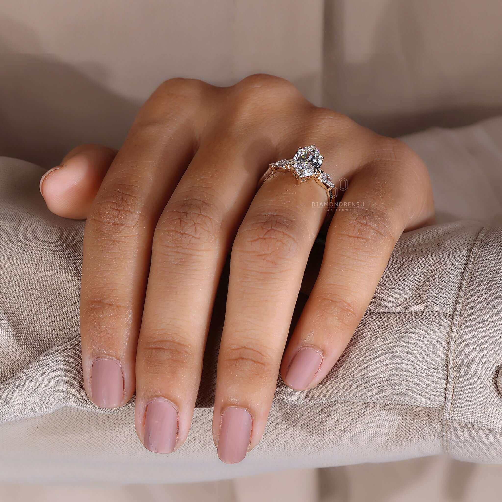 Two side kite cut stones framing a centre diamond for added brilliance and elegance.