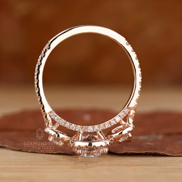 3 stone halo design in rose gold setting.
