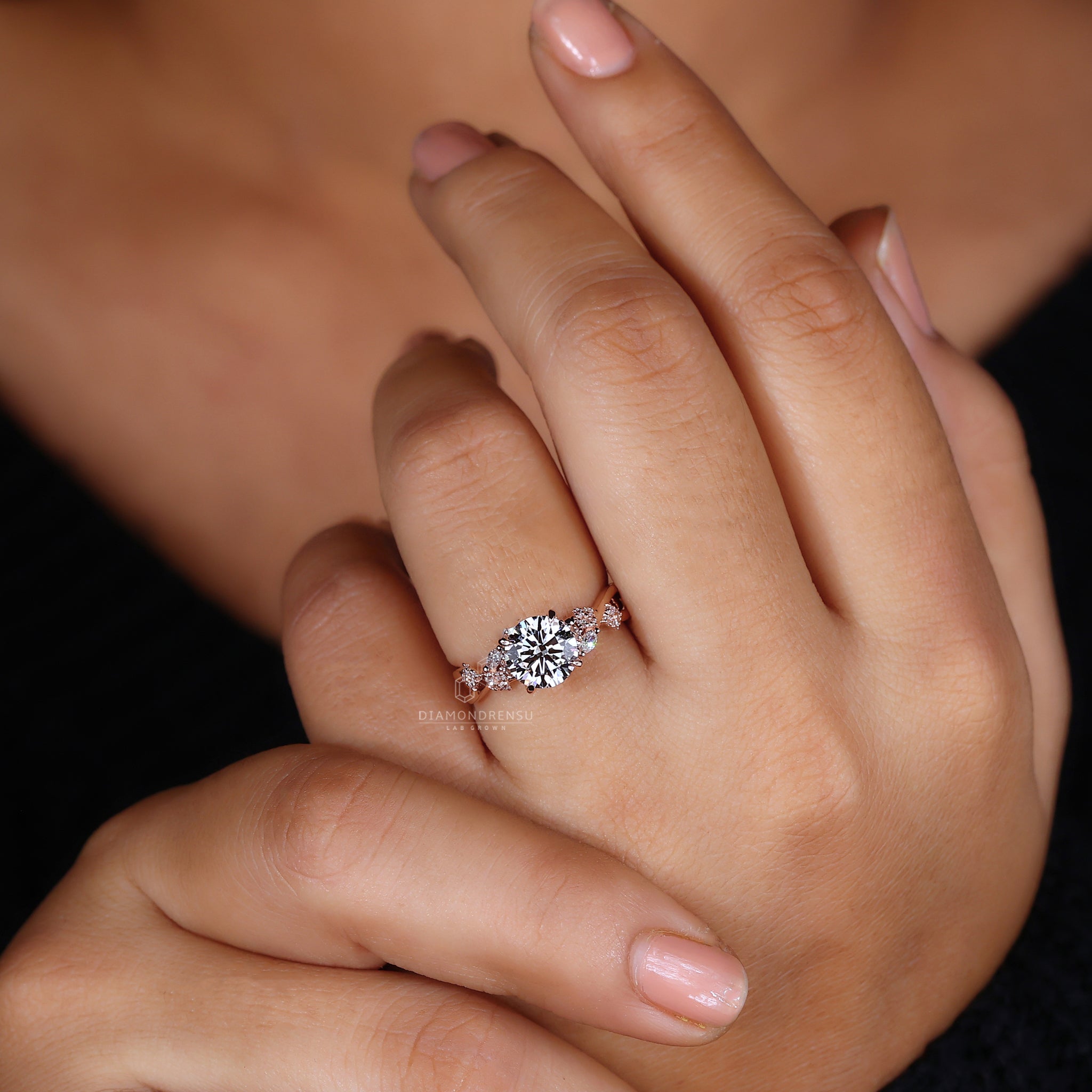 Marquise and round side stone ring in a rose gold setting.