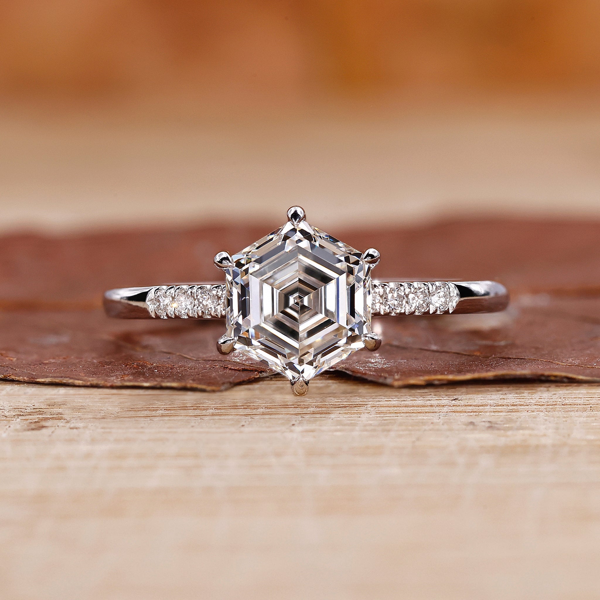 Hexagon ring paired with round cut side stones.
