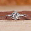 Hexagon ring paired with round cut side stones.
