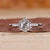 Hexagon ring paired with round cut side stones.

