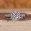 Cushion cut halo diamond ring with pave setting details.
