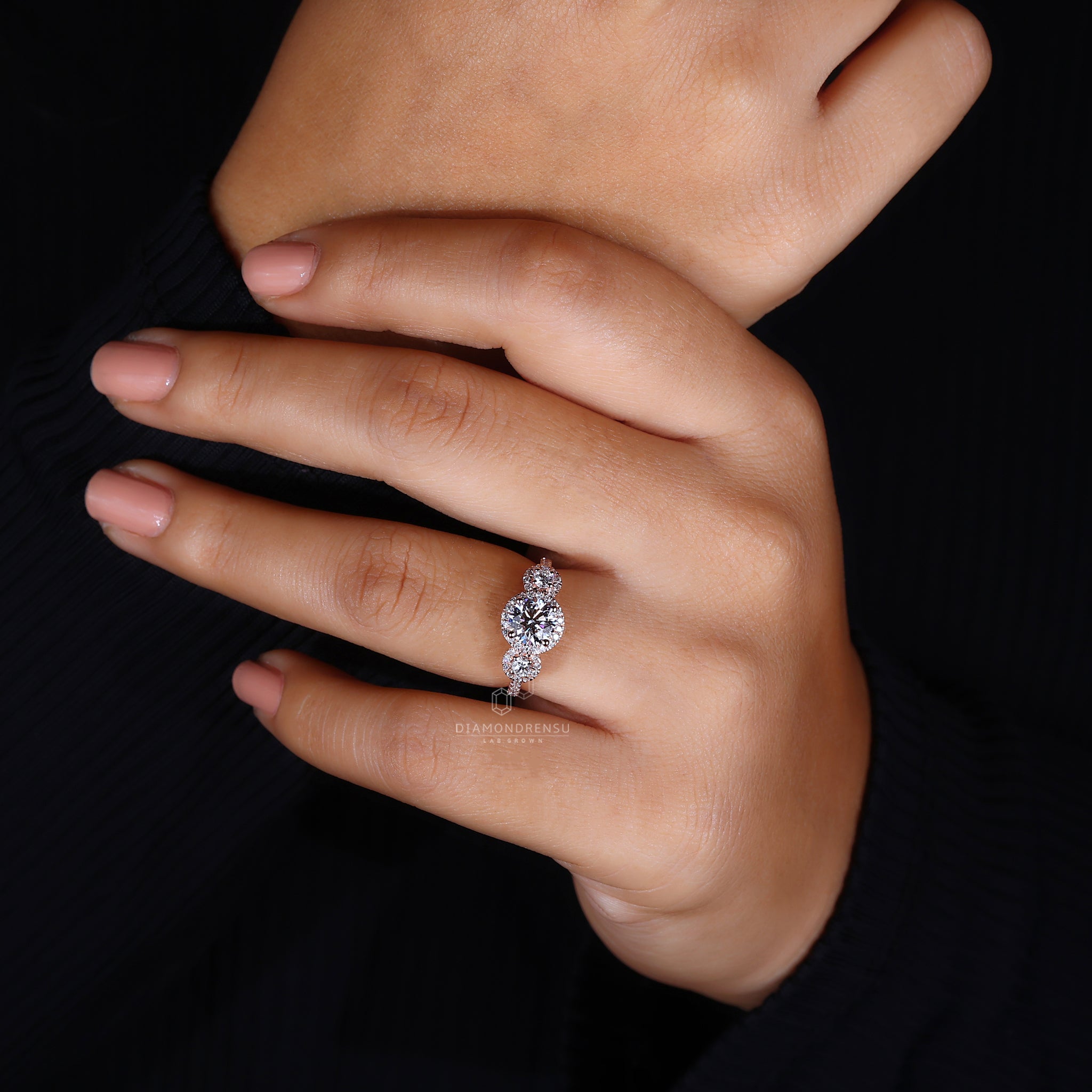 Round cut diamond three stone halo ring.
