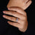 Round cut diamond three stone halo ring.
