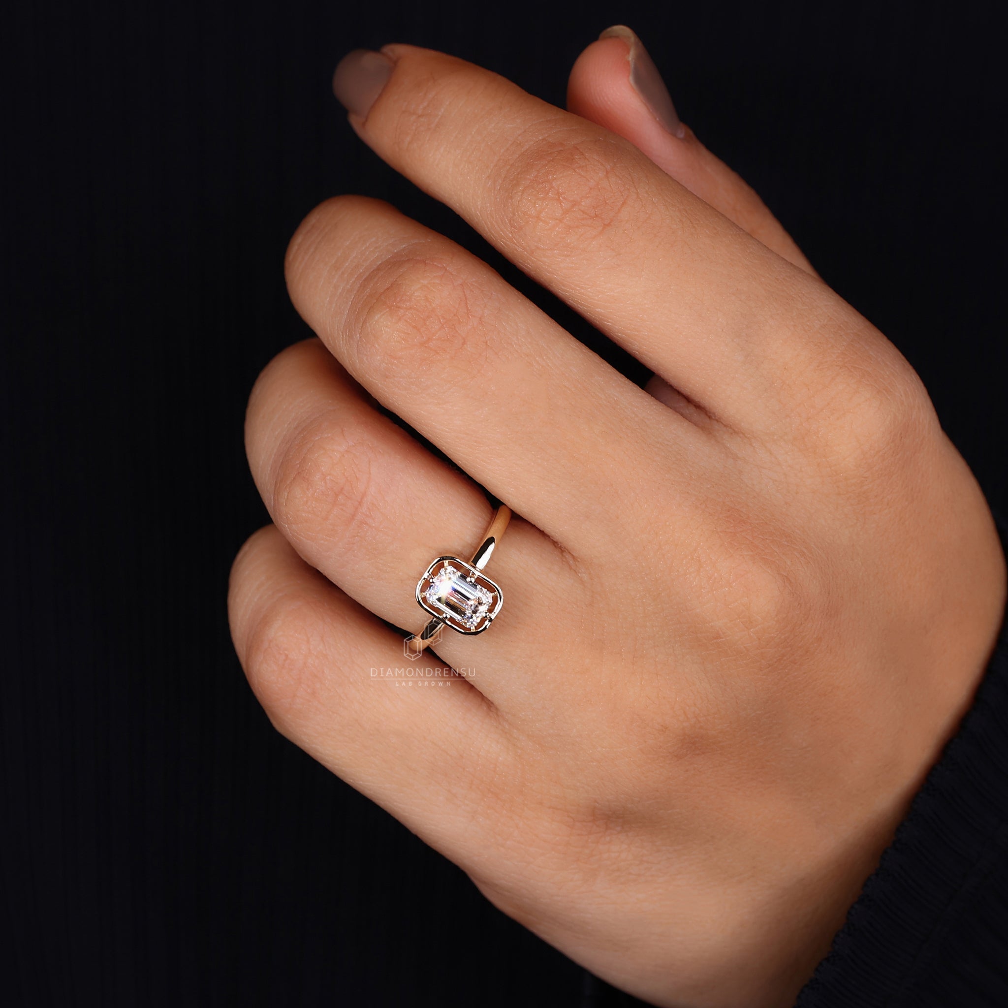 Yellow gold ring brings warmth to the emerald design.

