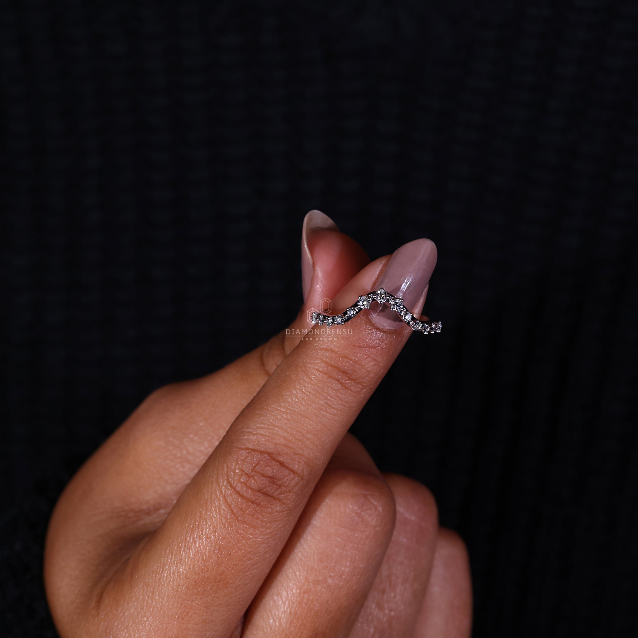 Elegant curved white gold diamond band.
