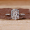 Radiant cut diamond ring with halo setting.
