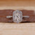 Radiant cut diamond ring with halo setting.
