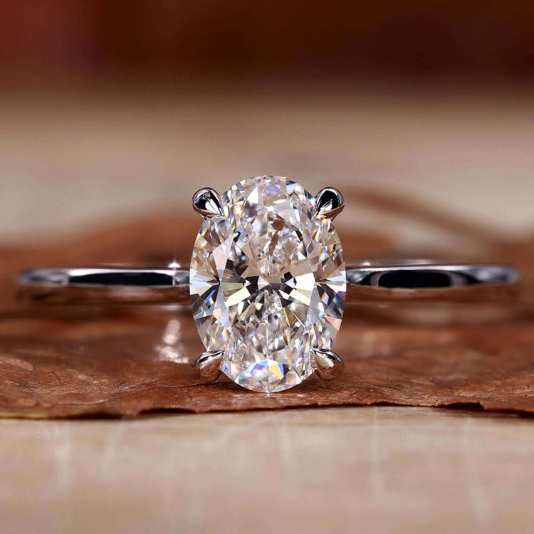Oval cut diamond ring in white gold with claw prong setting, perfect for engagements.