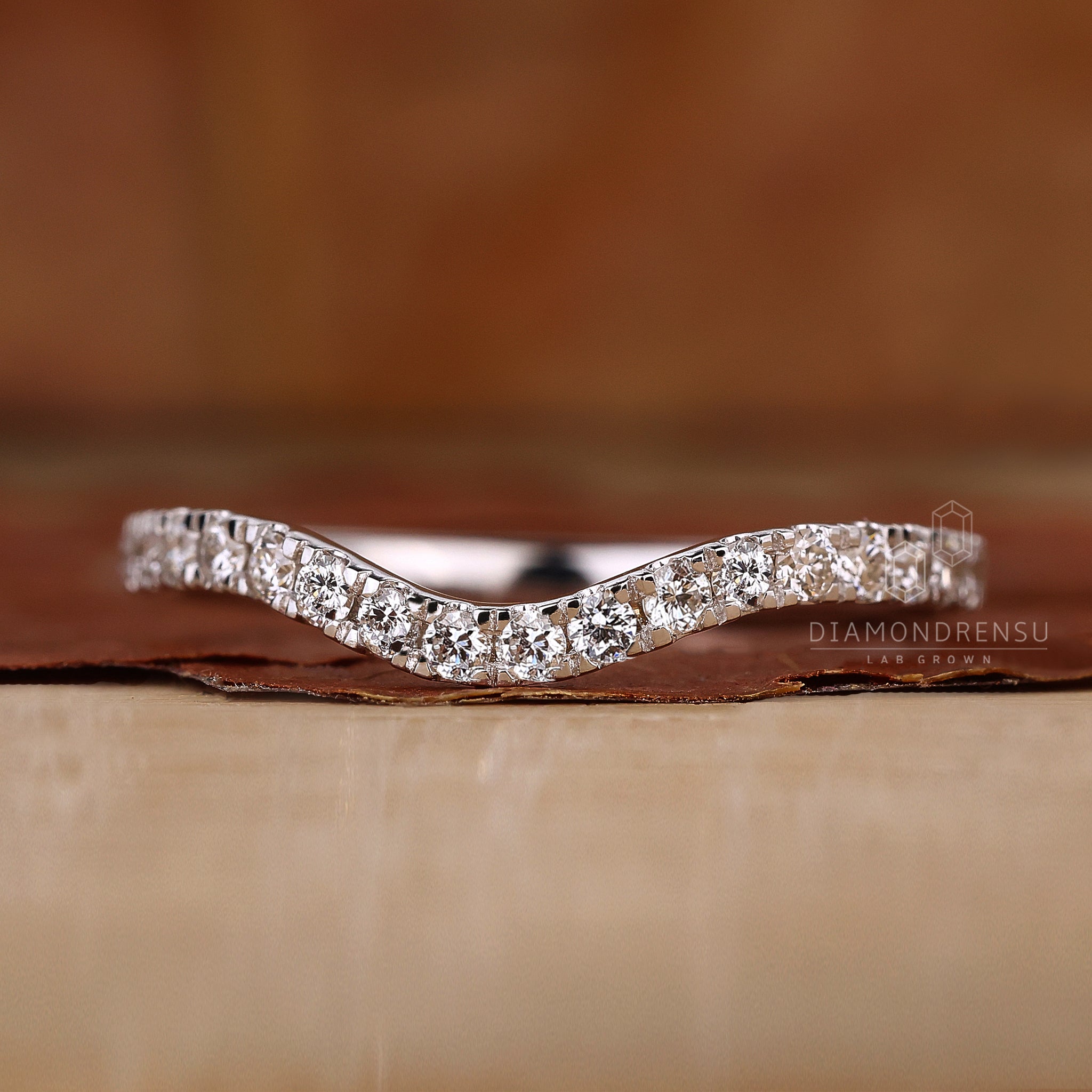 Lab grown diamond curved wedding band UK.
